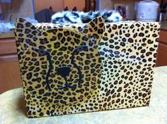 two leopard print bags sitting on top of a counter