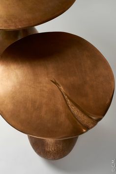 three metal plates stacked on top of each other in the shape of an abstract sculpture