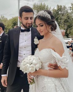 the bride and groom are walking together