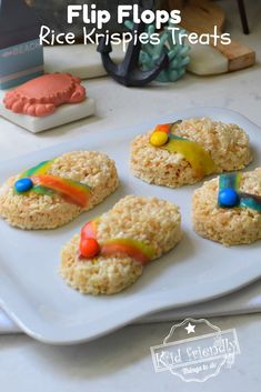 rice krispies are decorated with colorful candies and candy flakes on a white plate