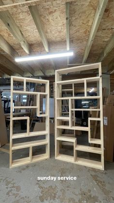 two wooden shelves in the middle of a room filled with boxes and other furniture items