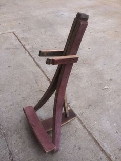 a wooden bench sitting on top of a cement ground