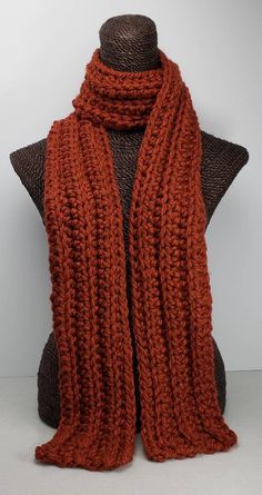 This scarf will keep you cozy and stylish in cold Winter weather. Measures 70 inches long and 5 inches wide. Can be worn multiple ways. Made with a chunky wool blend yarn for warmth and easy care. Machine washable. Orange Crochet Scarf, Big Knitted Scarf, Dark Orange Clothes, Chunky Knitted Scarf, Orange Crochet Ideas, Crochet Fall Scarf, Crochet Winter Scarf, Unique Knitwear, Chunky Crochet Scarf