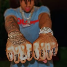 a person with tattoos on their hands and the word truth written in both of them