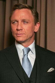 a man in a suit and blue tie