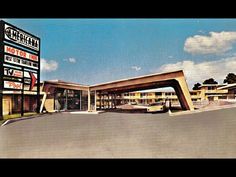 an old photo of the outside of a motel