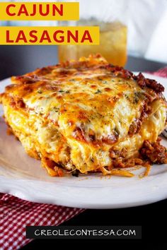 a white plate topped with lasagna covered in cheese