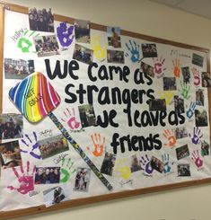 a bulletin board with handprints on it that says we care as strangers, we leave friends