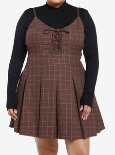 Class is in session! Get the dark academia look with this twofer dress! Featuring a brown plaid dress with lace-up detailing at the chest and a pleated skirt. Comes with a black mock neck long-sleeve underneath  adjustable straps  side zipper and pockets.Please note: Dress is fitted with no stretch; size up for a looser fit.65% polyester; 35% rayonWash cold; dry lowLength: 40''ImportedModel is 5'10''Model wears size 1 Fashion For Chubby Ladies, Plus Size Pastel Goth, Brown Plaid Dress, Academia Look, Dark Academia Look, Twofer Dress, Casual Dresses Plus Size, Academia Style, Dark Academia Fashion