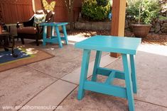 two blue stools sitting on top of a patio