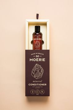 a bottle of mcorerie in a box on the wall