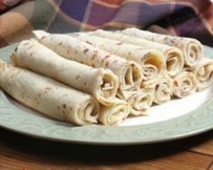 some tortillas are stacked on a plate and ready to be eaten by someone