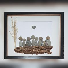 a group of pebbles sitting on top of a rock formation in a frame