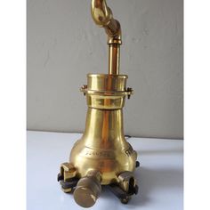 an antique brass oil lamp with three knobs