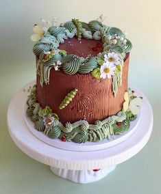 a chocolate cake with green frosting and flowers