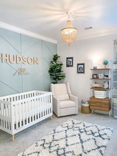 a baby's room with a white crib and blue walls