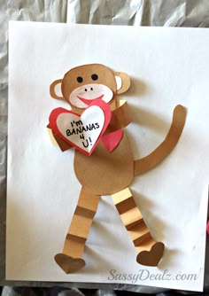 a paper monkey holding a heart with the words i'm bananas on it,