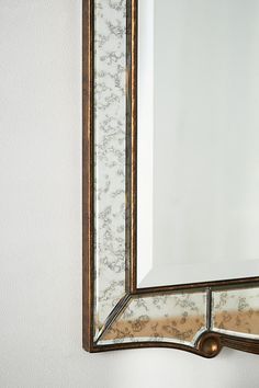 a mirror mounted to the side of a wall