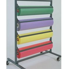 a multicolored rolling rack with six rolls of paper on it's wheels