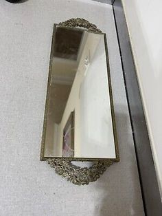 a mirror sitting on the floor next to a wall