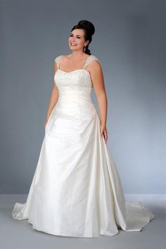 a woman in a wedding dress posing for the camera