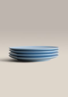 four blue plates stacked on top of each other