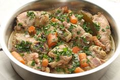 a pot filled with meat and vegetables on top of a table