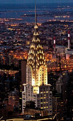 the empire building is lit up at night in new york city, with its lights on