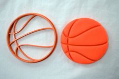 two orange plastic basketballs sitting next to each other