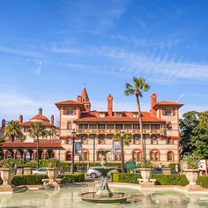 a large building with a fountain in front of it