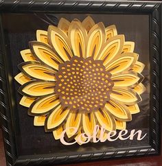 a yellow and brown flower with the word queen written in cursive writing on it