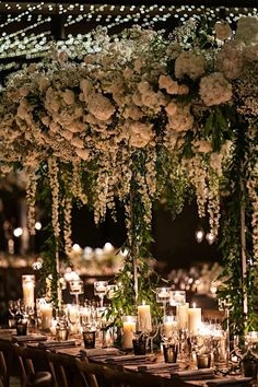 a long table with candles and flowers on it is set up for a formal function