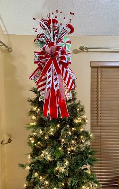 a christmas tree decorated with candy canes and bows