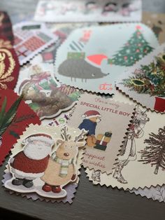 many different christmas stickers on a table