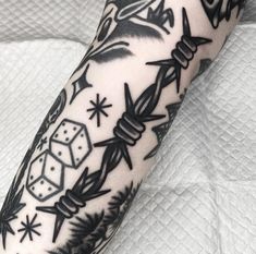 a black and white photo of a tattoo on someone's arm with dices