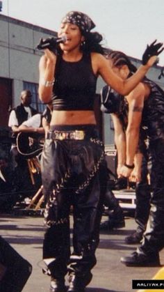 two women in leather outfits are performing on stage