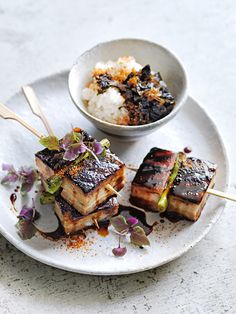 a plate with tofu, rice and vegetables on it