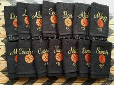 black towels with basketballs on them sitting on a wooden table next to each other