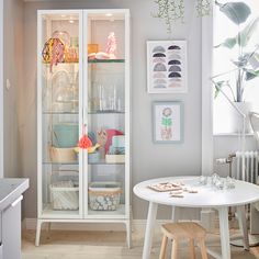 a white table and some shelves in a room