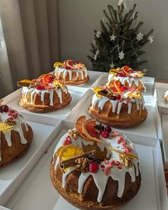 several cakes with icing and fruit on them