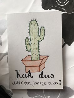 a card with a drawing of a cactus in a box on it's side