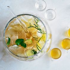 a glass bowl filled with lemonade and ice