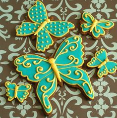 decorated cookies in the shape of butterflies on a table