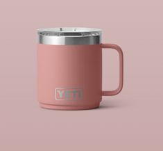 the yeti coffee mug is shown on a pink background