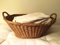 a wicker basket sitting on top of a bed