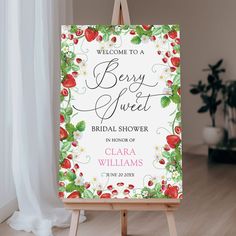 a welcome sign for a bridal shower is displayed on an easel in front of a window