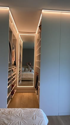 a bedroom with white walls and built in closets