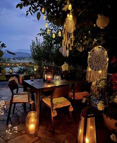 an outdoor dining area with candles and lanterns