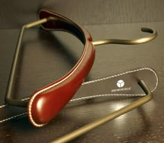 a pair of glasses sitting on top of a wooden table next to a metal bar