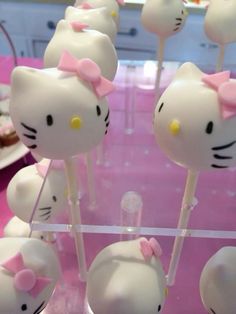 hello kitty lollipops on sticks with pink bows are ready to be eaten